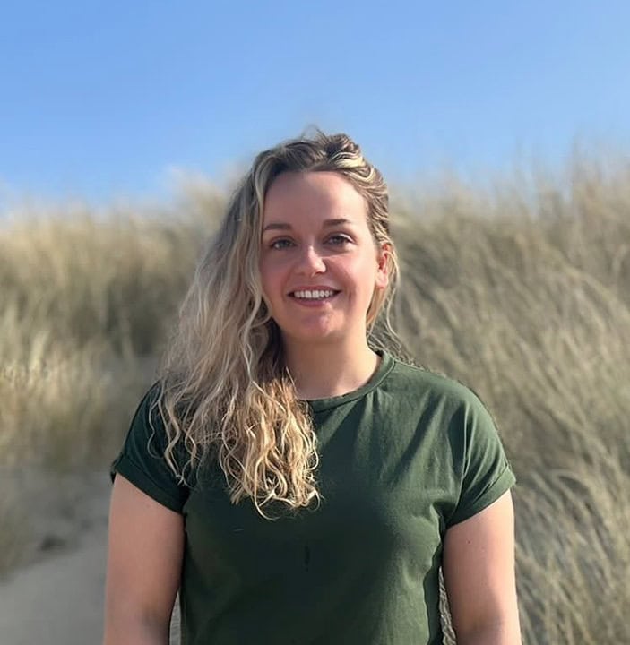 Eleanor Strange standing in a beautiful sand dune