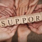 Mental Health Blog Multiple hands holding up wooden blocks displaying the word "Support"